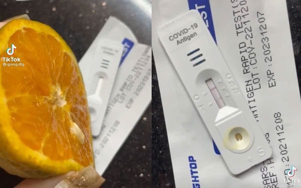 The creator of the video uses orange juice on a Covid-19 test strip, resulting in two lines.
