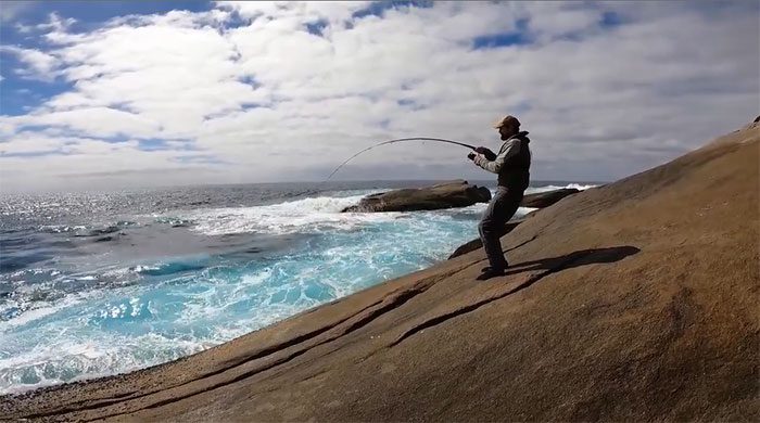 A daring man fishing in a rarely visited location.