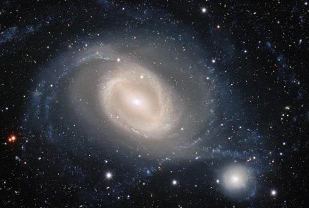 The moment two galaxies are about to collide, where the larger galaxy will swallow the smaller one