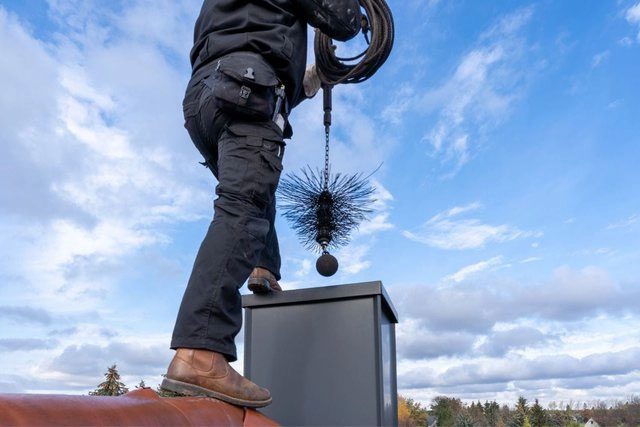Chimney sweep and his characteristic brush.
