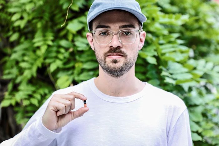 Luke Brown, 29, in New York, USA, holding a TPOXX pill.
