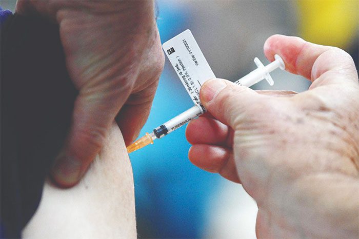 Administering COVID-19 vaccine to residents in Sydney, Australia.