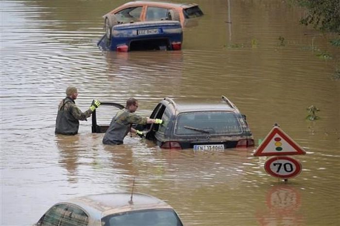 German soldiers search for and assist victims in vehicles submerged by floodwaters