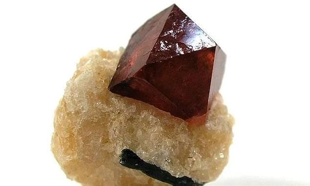 A large zircon crystal mounted on a base made of calcite