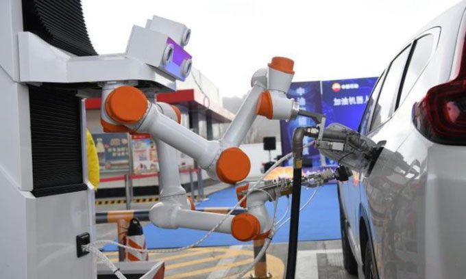Automated robotic arms refueling vehicles.
