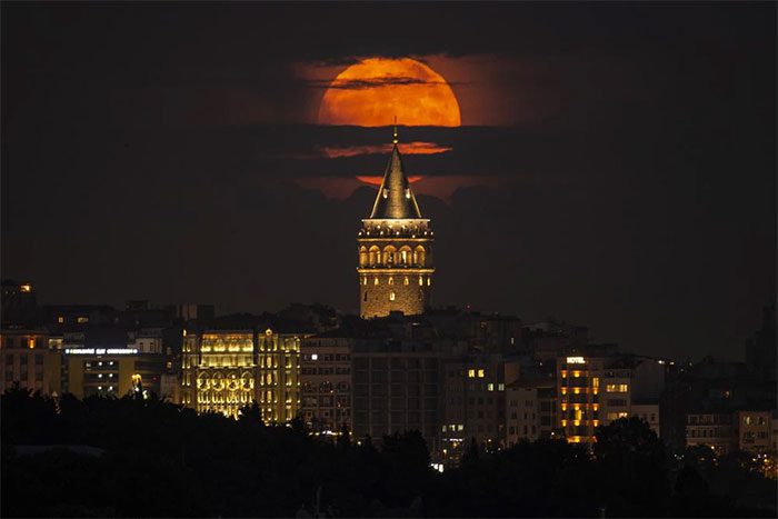 A supermoon appears behind the Galata Tower in Istanbul (Turkey) on June 14.