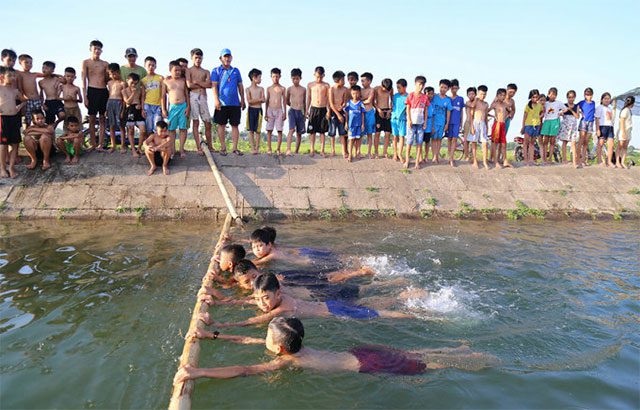 Children in Hai Lang, Quang Tri Province, learning to swim in an irrigation canal.