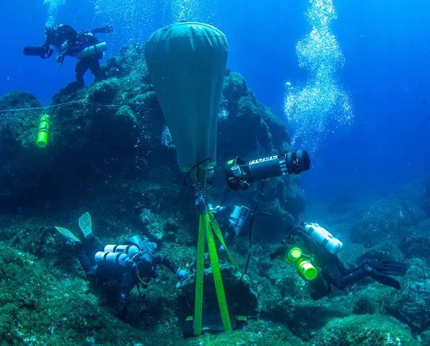 The process of recovering artifacts from the shipwreck at a depth of 50 meters beneath the sea.