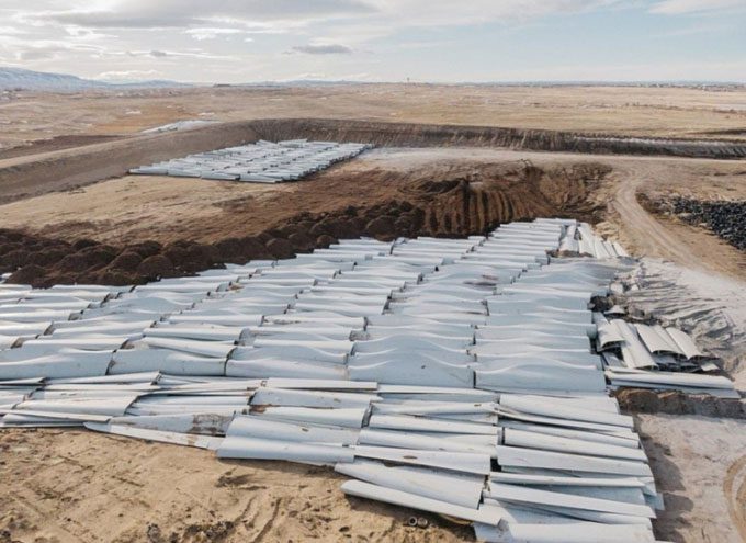 Without effective recycling measures, old wind turbine blades are stacked in Sweetwater