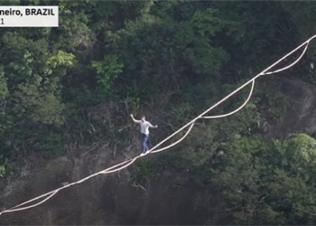 watching a man walk on a rope between two high peaks 118022