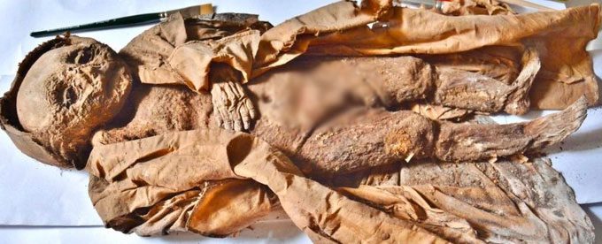 Mummified child in a silk cloak