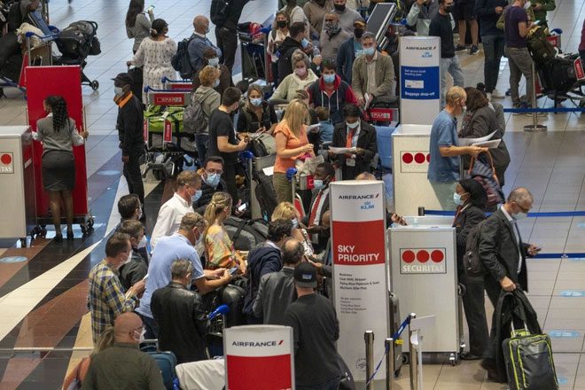 Passengers queue at Johannesburg airport to leave South Africa following news of Omicron