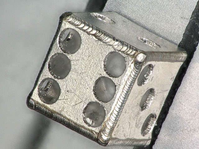 A metal die with faces measuring just 1mm.