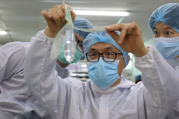 Gynecologist John Tang Ing Chinh examining the new condom sample