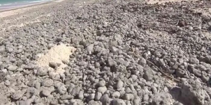 The coastline turns gray due to a large amount of trapped pumice.