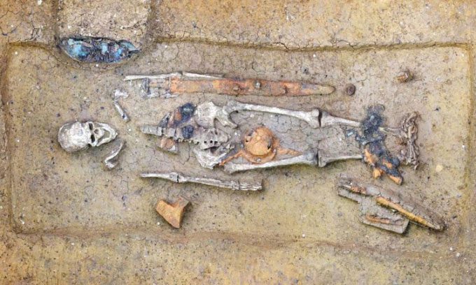 The tomb containing the skeletal remains of a Medieval man and various artifacts.