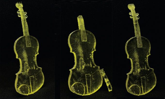 3D printed violin with self-healing additives under ultraviolet LED light.