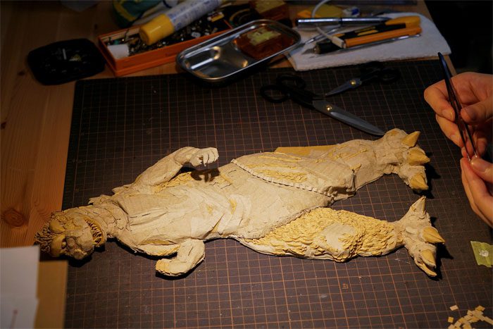 A cardboard monster sculpture.