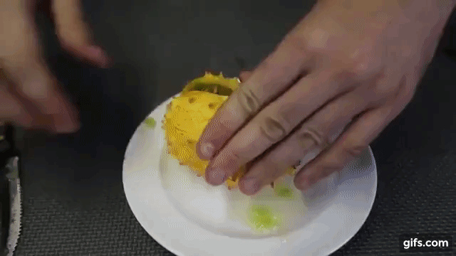 Cut the melon in half to see the green, seed-filled flesh.