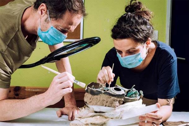 Scientists restoring artifacts in the lab