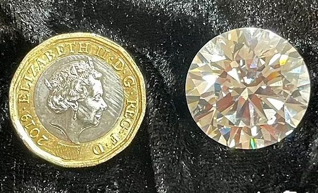 The diamond is larger than a one-pound coin.