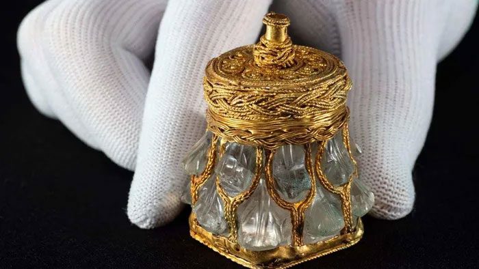The gold-covered crystal vase was used for royal perfumes or oils.