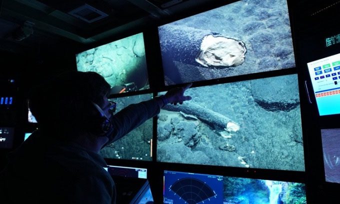 Scientist Steven Haddock points to the tusk on the screen of the Western Flyer.