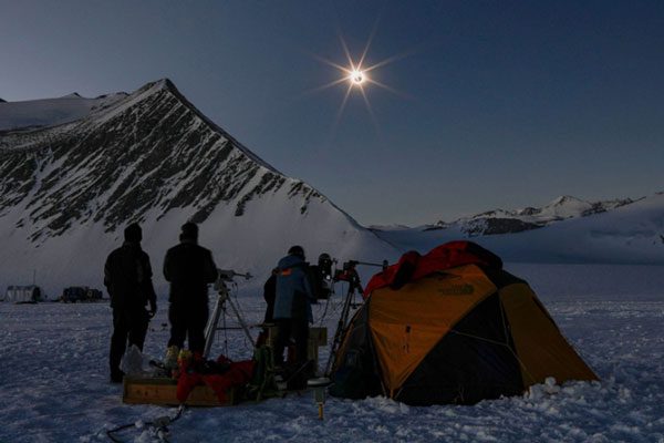 American and Chilean scientists observing the eclipse from Union Glacier camp, Antarctica, on December 4
