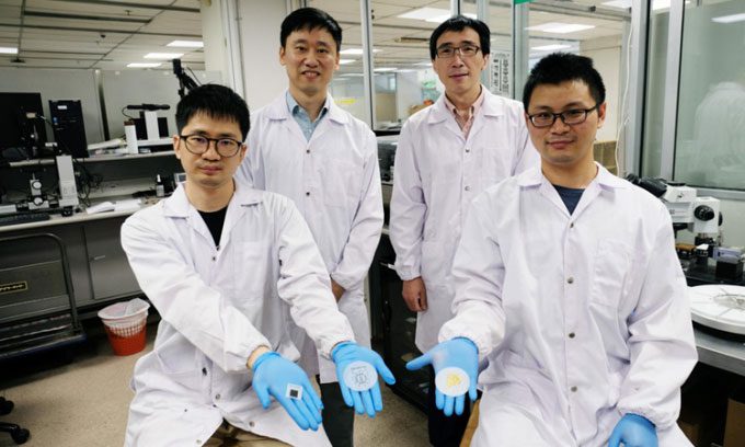 Research team with three versions of paper batteries.