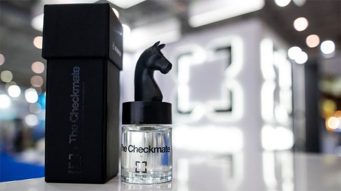 Glass perfume bottle with a black horse-head cap.