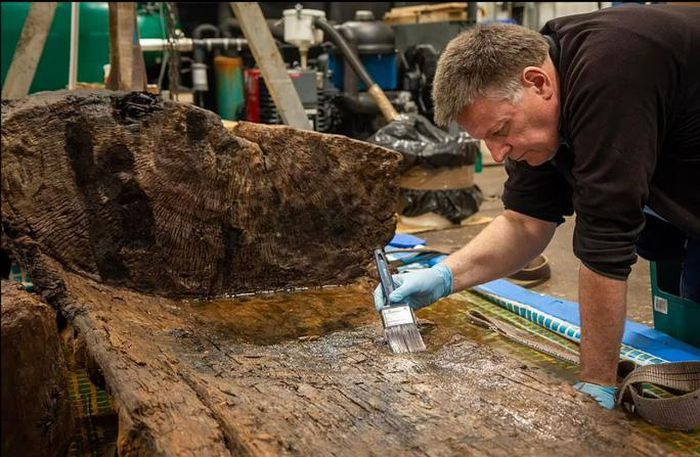 An archaeologist working with the special coffin