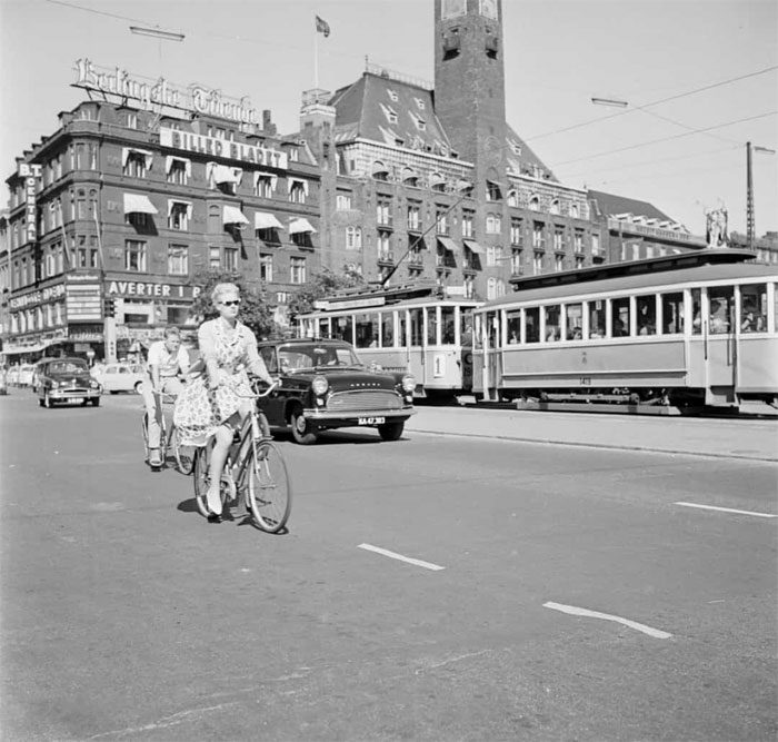 A woman cycling on the streets of Copenhagen, Denmark