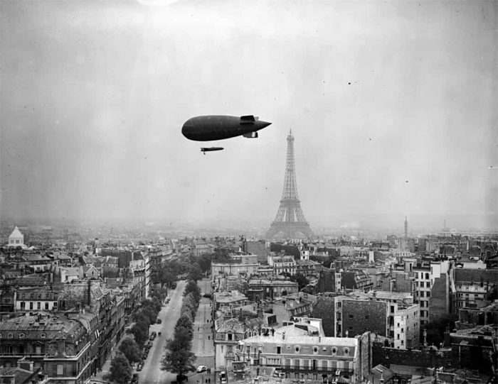 A hot air balloon flying over the city of Paris, France