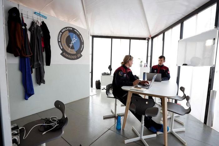 Scientists sitting together at the facility during the experiment demonstration.