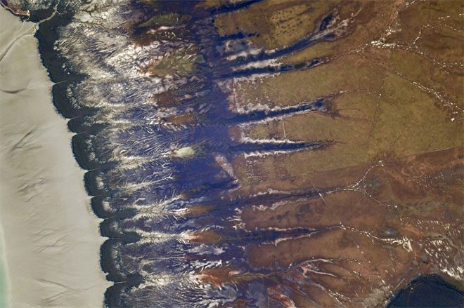 These colorful patterns are actually a sand dune in Australia, captured on May 14.