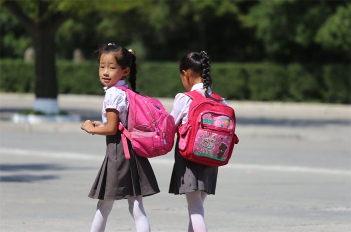 Two North Korean girls in school uniforms