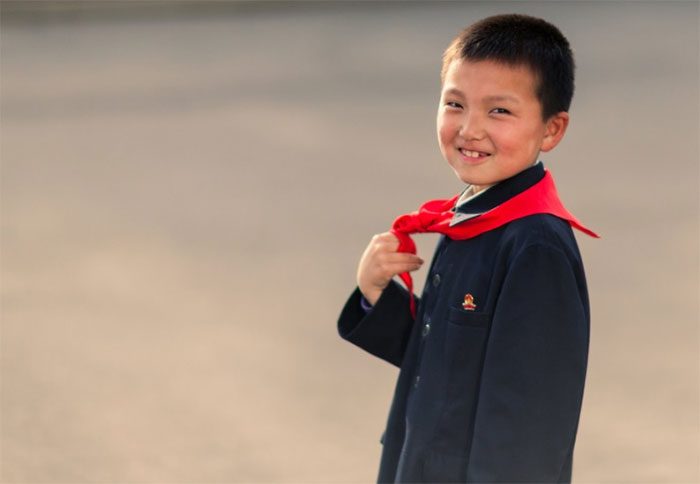 A boy wearing the red scarf typical of the North Korean Children's Union