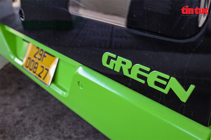 Electric bus registered with a yellow license plate for commercial vehicles.